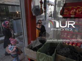 An Iranian family is standing in front of a supermarket at a bazaar in the flooded village of Imamzadeh Davood in the northwestern part of T...