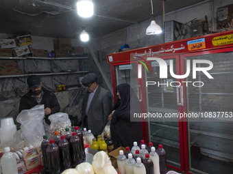 An Iranian man and an elderly veiled woman are shopping at a bazaar in the flooded village of Imamzadeh Davood in the northwestern part of T...