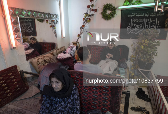 An Iranian family is sitting at a traditional restaurant in the flooded village of Imamzadeh Davood in the northwestern part of Tehran, on D...