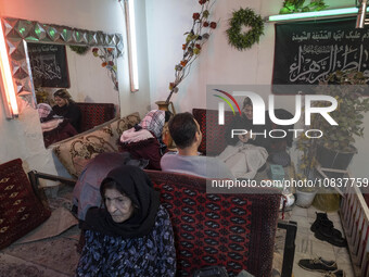 An Iranian family is sitting at a traditional restaurant in the flooded village of Imamzadeh Davood in the northwestern part of Tehran, on D...