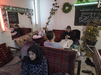 An Iranian family is sitting at a traditional restaurant in the flooded village of Imamzadeh Davood in the northwestern part of Tehran, on D...