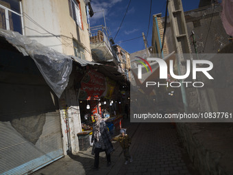 An Iranian woman and her young son are walking through a bazaar while visiting the flooded village of Imamzadeh Davood in the northwestern p...