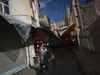 An Iranian woman and her young son are walking through a bazaar while visiting the flooded village of Imamzadeh Davood in the northwestern p...