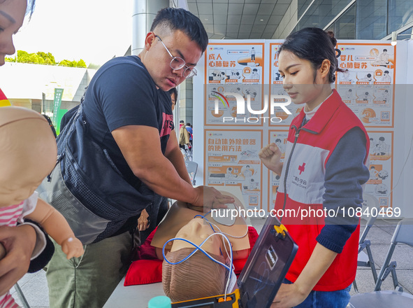 Participants are practicing cardiopulmonary resuscitation (CPR) at the 2023 China-ASEAN Health Industry Summit in Nanning, Guangxi, China, o...