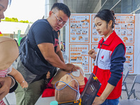 Participants are practicing cardiopulmonary resuscitation (CPR) at the 2023 China-ASEAN Health Industry Summit in Nanning, Guangxi, China, o...