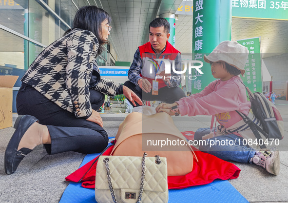 Participants are practicing cardiopulmonary resuscitation (CPR) at the 2023 China-ASEAN Health Industry Summit in Nanning, Guangxi, China, o...