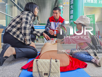 Participants are practicing cardiopulmonary resuscitation (CPR) at the 2023 China-ASEAN Health Industry Summit in Nanning, Guangxi, China, o...