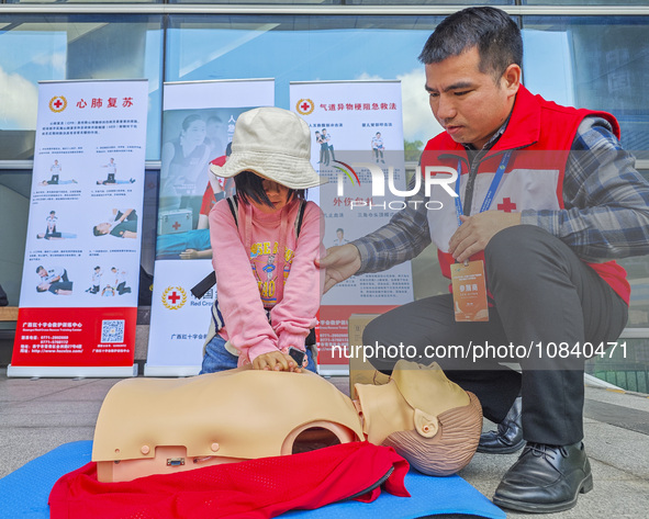 Participants are practicing cardiopulmonary resuscitation (CPR) at the 2023 China-ASEAN Health Industry Summit in Nanning, Guangxi, China, o...