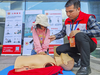 Participants are practicing cardiopulmonary resuscitation (CPR) at the 2023 China-ASEAN Health Industry Summit in Nanning, Guangxi, China, o...