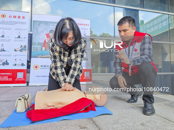 Participants are practicing cardiopulmonary resuscitation (CPR) at the 2023 China-ASEAN Health Industry Summit in Nanning, Guangxi, China, o...