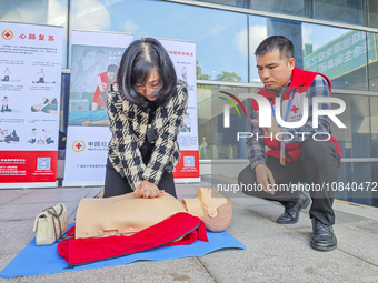 Participants are practicing cardiopulmonary resuscitation (CPR) at the 2023 China-ASEAN Health Industry Summit in Nanning, Guangxi, China, o...