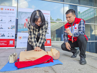 Participants are practicing cardiopulmonary resuscitation (CPR) at the 2023 China-ASEAN Health Industry Summit in Nanning, Guangxi, China, o...