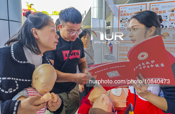 Participants are practicing cardiopulmonary resuscitation (CPR) at the 2023 China-ASEAN Health Industry Summit in Nanning, Guangxi, China, o...