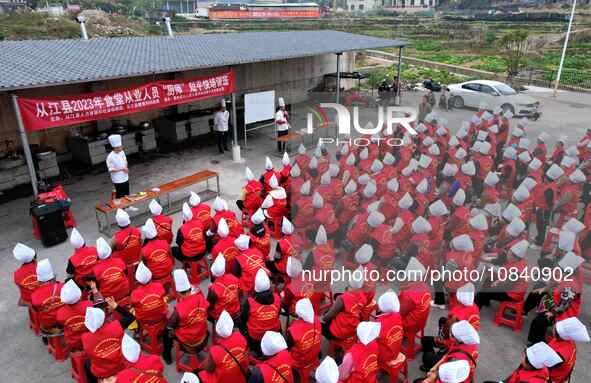 A mechanic teacher is training workers on cooking skills at a primary and secondary school canteen in Qiandongnan, Guizhou Province, China,...