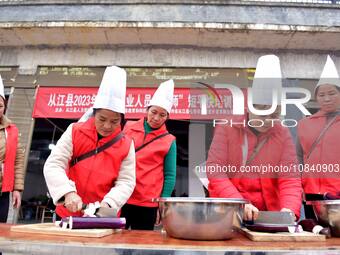 A mechanic teacher is training workers on cooking skills at a primary and secondary school canteen in Qiandongnan, Guizhou Province, China,...