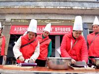 A mechanic teacher is training workers on cooking skills at a primary and secondary school canteen in Qiandongnan, Guizhou Province, China,...