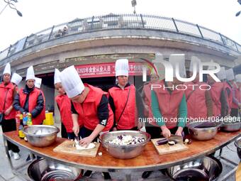 A mechanic teacher is training workers on cooking skills at a primary and secondary school canteen in Qiandongnan, Guizhou Province, China,...