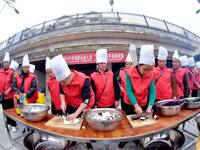 A mechanic teacher is training workers on cooking skills at a primary and secondary school canteen in Qiandongnan, Guizhou Province, China,...