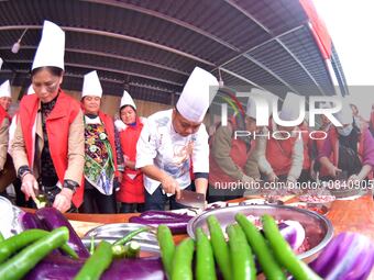 A mechanic teacher is training workers on cooking skills at a primary and secondary school canteen in Qiandongnan, Guizhou Province, China,...