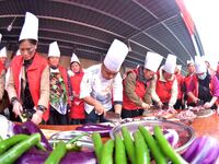 A mechanic teacher is training workers on cooking skills at a primary and secondary school canteen in Qiandongnan, Guizhou Province, China,...