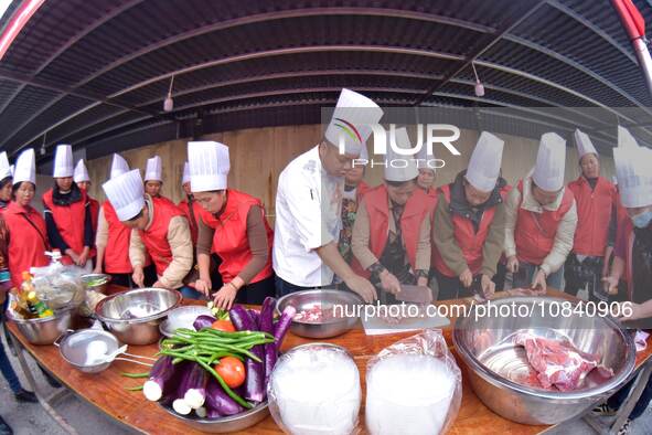 A mechanic teacher is training workers on cooking skills at a primary and secondary school canteen in Qiandongnan, Guizhou Province, China,...