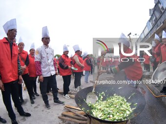 A mechanic teacher is training workers on cooking skills at a primary and secondary school canteen in Qiandongnan, Guizhou Province, China,...