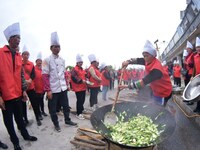 A mechanic teacher is training workers on cooking skills at a primary and secondary school canteen in Qiandongnan, Guizhou Province, China,...