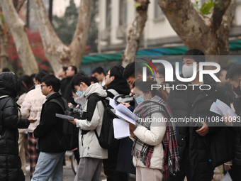 Candidates are waiting to enter the written exam of the Jiangsu 2024 civil servant exam in Nanjing, Jiangsu Province, China, on December 10,...