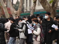 Candidates are waiting to enter the written exam of the Jiangsu 2024 civil servant exam in Nanjing, Jiangsu Province, China, on December 10,...