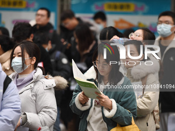 Candidates are waiting to enter the written exam of the Jiangsu 2024 civil servant exam in Nanjing, Jiangsu Province, China, on December 10,...