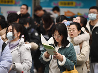 Candidates are waiting to enter the written exam of the Jiangsu 2024 civil servant exam in Nanjing, Jiangsu Province, China, on December 10,...