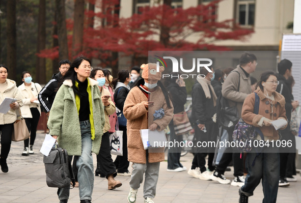 Candidates are waiting to enter the written exam of the Jiangsu 2024 civil servant exam in Nanjing, Jiangsu Province, China, on December 10,...