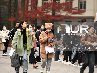 Candidates are waiting to enter the written exam of the Jiangsu 2024 civil servant exam in Nanjing, Jiangsu Province, China, on December 10,...