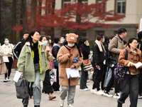 Candidates are waiting to enter the written exam of the Jiangsu 2024 civil servant exam in Nanjing, Jiangsu Province, China, on December 10,...