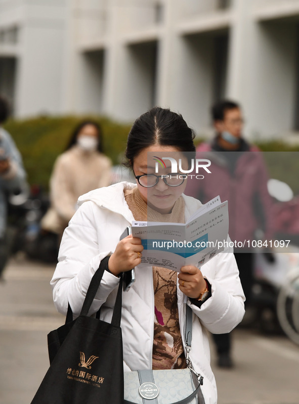 Candidates are waiting to enter the written exam of the Jiangsu 2024 civil servant exam in Nanjing, Jiangsu Province, China, on December 10,...