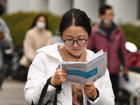 Candidates are waiting to enter the written exam of the Jiangsu 2024 civil servant exam in Nanjing, Jiangsu Province, China, on December 10,...