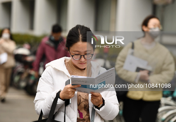 Candidates are waiting to enter the written exam of the Jiangsu 2024 civil servant exam in Nanjing, Jiangsu Province, China, on December 10,...