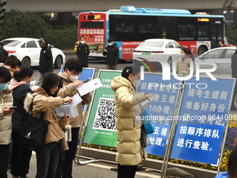 Candidates are waiting to enter the written exam of the Jiangsu 2024 civil servant exam in Nanjing, Jiangsu Province, China, on December 10,...