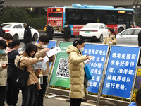 Candidates are waiting to enter the written exam of the Jiangsu 2024 civil servant exam in Nanjing, Jiangsu Province, China, on December 10,...