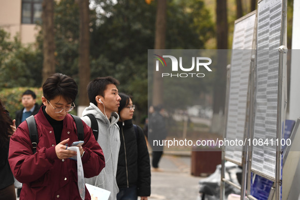 Candidates are waiting to enter the written exam of the Jiangsu 2024 civil servant exam in Nanjing, Jiangsu Province, China, on December 10,...