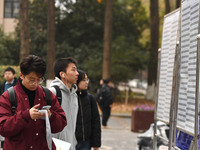 Candidates are waiting to enter the written exam of the Jiangsu 2024 civil servant exam in Nanjing, Jiangsu Province, China, on December 10,...