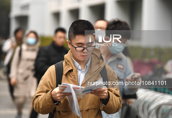 Candidates are waiting to enter the written exam of the Jiangsu 2024 civil servant exam in Nanjing, Jiangsu Province, China, on December 10,...