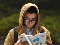 Candidates are waiting to enter the written exam of the Jiangsu 2024 civil servant exam in Nanjing, Jiangsu Province, China, on December 10,...