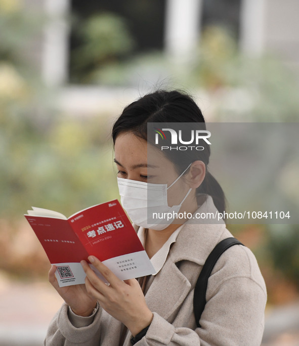 Candidates are waiting to enter the written exam of the Jiangsu 2024 civil servant exam in Nanjing, Jiangsu Province, China, on December 10,...