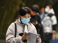 Candidates are waiting to enter the written exam of the Jiangsu 2024 civil servant exam in Nanjing, Jiangsu Province, China, on December 10,...