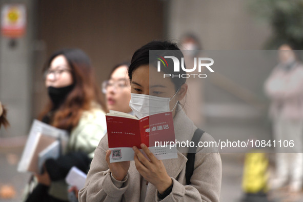 Candidates are waiting to enter the written exam of the Jiangsu 2024 civil servant exam in Nanjing, Jiangsu Province, China, on December 10,...