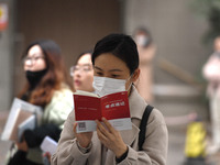 Candidates are waiting to enter the written exam of the Jiangsu 2024 civil servant exam in Nanjing, Jiangsu Province, China, on December 10,...