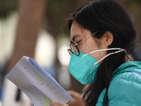 Candidates are waiting to enter the written exam of the Jiangsu 2024 civil servant exam in Nanjing, Jiangsu Province, China, on December 10,...