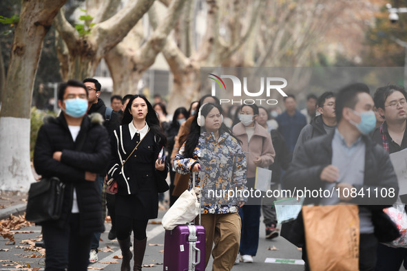 Candidates are waiting to enter the written exam of the Jiangsu 2024 civil servant exam in Nanjing, Jiangsu Province, China, on December 10,...