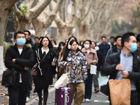 Candidates are waiting to enter the written exam of the Jiangsu 2024 civil servant exam in Nanjing, Jiangsu Province, China, on December 10,...